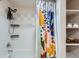Shower with colorful shower curtain and storage caddies at 2715 Blake St # 2, Denver, CO 80205