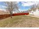 Large grassy backyard with wood fence providing privacy for outdoor enjoyment at 6426 Zang Ct, Arvada, CO 80004