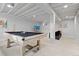 Large finished basement with a modern pool table, comfortable seating, and a media area at 6426 Zang Ct, Arvada, CO 80004