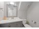 Bathroom featuring a single sink vanity, toilet and small mirror at 6426 Zang Ct, Arvada, CO 80004