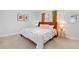 Bright bedroom featuring an orange accent wall and a comfortable king-size bed at 6426 Zang Ct, Arvada, CO 80004