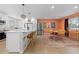 Open-concept kitchen and dining area with modern island seating and stainless steel appliances at 6426 Zang Ct, Arvada, CO 80004