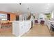 Open kitchen boasts a spacious island, stainless steel appliances, and stylish pendant lighting at 6426 Zang Ct, Arvada, CO 80004