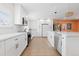Bright kitchen featuring white cabinetry, stainless steel appliances, and a center island with a sink at 6426 Zang Ct, Arvada, CO 80004