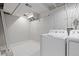 Clean and organized laundry area with modern white appliances and tile flooring at 6426 Zang Ct, Arvada, CO 80004