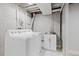 Functional laundry room with modern appliances, sink, and clean finishes at 6426 Zang Ct, Arvada, CO 80004