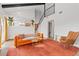Bright and airy living room featuring a staircase and open wall to kitchen area at 6426 Zang Ct, Arvada, CO 80004