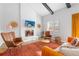 Cozy living room featuring a fireplace, bright furniture, and a large window for natural light at 6426 Zang Ct, Arvada, CO 80004