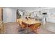 Open layout featuring kitchen and dining spaces with hardwood floors and natural light at 6426 Zang Ct, Arvada, CO 80004