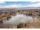 A serene pond surrounded by trees and walking paths at 6426 Zang Ct, Arvada, CO 80004