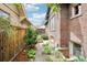 Charming backyard with stone walkway, mature landscaping, privacy fence, and a gazebo beyond at 4253 Hooker St, Denver, CO 80211