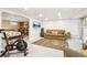 Basement living area with exercise bike, wall mounted television, comfortable seating, and built-in storage at 4253 Hooker St, Denver, CO 80211