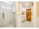This bathroom features a glass enclosed shower and a vanity cabinet, offering a sleek and contemporary design at 4253 Hooker St, Denver, CO 80211