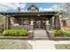 Charming brick home with a covered porch and well-manicured landscaping, inviting and full of curb appeal at 4253 Hooker St, Denver, CO 80211