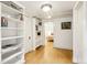Hallway featuring hardwood floors, white trim, recessed lighting, and built-in shelving leading to bedroom at 4253 Hooker St, Denver, CO 80211