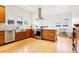 Bright kitchen featuring stainless steel appliances, wood cabinets, and a large farmhouse sink at 4253 Hooker St, Denver, CO 80211