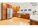 Spacious kitchen with stainless steel fridge, wood cabinets, and hardwood flooring at 4253 Hooker St, Denver, CO 80211