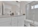 Beautiful bathroom featuring double sinks, white cabinets and a glass shower at 2140 S Ash St # 103, Denver, CO 80222