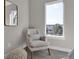 Light and airy bedroom space with a large sunny window and comfortable chair at 2140 S Ash St # 103, Denver, CO 80222