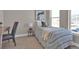 Bright bedroom featuring a desk, twin bed with striped bedding, and a neutral color scheme at 2140 S Ash St # 103, Denver, CO 80222