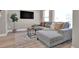 Relax in this stylish living room featuring an oversized sectional couch and modern accents at 2140 S Ash St # 103, Denver, CO 80222