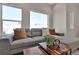 Comfortable living room with large windows and an oversized sectional sofa at 2140 S Ash St # 103, Denver, CO 80222