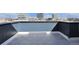 Rooftop deck features deck pavers and views of city buildings on a sunny day at 2140 S Ash St # 103, Denver, CO 80222