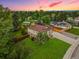 A beautiful aerial view showcases the landscaped yard, mature trees, and classic home exterior at 5954 W Leawood Dr, Littleton, CO 80123