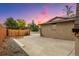 View of the backyard concrete area, privacy fence, and exterior brick wall at 5954 W Leawood Dr, Littleton, CO 80123