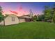 A view of the backyard shows a shed and a covered patio on a large lot at 5954 W Leawood Dr, Littleton, CO 80123