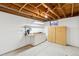 Unfinished basement workshop area with cabinets and storage at 5954 W Leawood Dr, Littleton, CO 80123