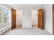 Bedroom featuring two closets with open doors and a window, allowing for ample natural light at 5954 W Leawood Dr, Littleton, CO 80123
