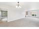 Expansive living room boasting neutral paint, plush carpeting, and natural light from large window at 5954 W Leawood Dr, Littleton, CO 80123