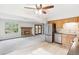Open floor plan featuring a fireplace in the living room adjacent to the kitchen and access to the deck through sliding doors at 5954 W Leawood Dr, Littleton, CO 80123
