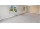 Bright living room with natural light from dual windows and plush carpeting at 5954 W Leawood Dr, Littleton, CO 80123