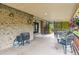 Covered patio features a grill and outdoor dining furniture overlooking a landscaped yard at 5954 W Leawood Dr, Littleton, CO 80123