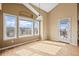 Open dining area bathed in natural light, showcasing wood floors and access to the outdoors at 7859 S Coolidge Way, Aurora, CO 80016