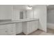 A large vanity and mirror add spaciousness to this white and granite bathroom at 9725 E Harvard Ave # 305, Denver, CO 80231