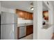 Kitchen with stainless steel appliances, granite countertops, and light-wood cabinets providing ample storage at 9725 E Harvard Ave # 305, Denver, CO 80231