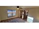 Bedroom with ceiling fan and private access to bathroom at 6567 Pierson St, Arvada, CO 80004