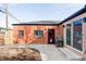 Brick exterior with a patio, a charming red door, and a grill, perfect for outdoor enjoyment at 3641 N Cook St, Denver, CO 80205