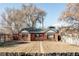 Quaint brick home with mature trees, a charming pergola, and a well-maintained front yard at 3641 N Cook St, Denver, CO 80205