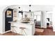 Contemporary kitchen with white cabinetry, granite countertops, stainless steel appliances, and dark hardwood floors at 3641 N Cook St, Denver, CO 80205