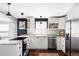 Bright kitchen features white cabinets, stainless steel appliances, and an island with a cooktop at 3641 N Cook St, Denver, CO 80205