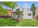 Grassy backyard with wood deck and pergola adjacent to a home at 744 Owl Dr, Louisville, CO 80027