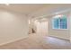 Finished basement features neutral carpet, a window, and recessed lighting at 744 Owl Dr, Louisville, CO 80027