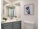 Cozy bathroom featuring a corner sink, framed flower art, and ample lighting at 744 Owl Dr, Louisville, CO 80027
