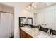 Bathroom featuring double sinks, granite countertops, and lots of light at 744 Owl Dr, Louisville, CO 80027