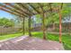Wood deck with pergola in a grassy, fenced backyard at 744 Owl Dr, Louisville, CO 80027