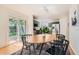 Cozy dining area adjacent to the kitchen, with a wooden table, black chairs and sliding glass door at 744 Owl Dr, Louisville, CO 80027